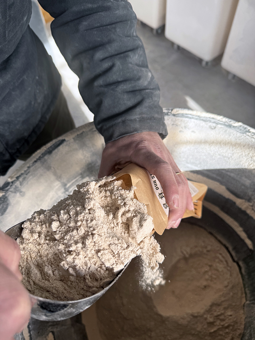 An image of scooping flour into a bag.